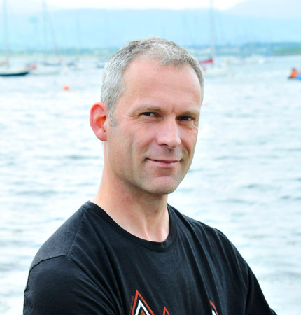 Head and shoulder photo of a smiling Andy Dale